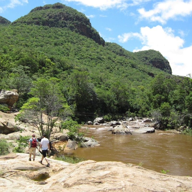 Two hikers walk along a pristine stream in the remote wilderness near Blyde Dam, surrounded by rugged landscapes and untouched natural beauty. Eswatini is an exceptional destination for hiking, offering diverse trails, dramatic scenery, and peaceful, crowd-free nature experiences. Discover these immersive outdoor adventures with your expert DMC and local travel agent, Inspiration Africa