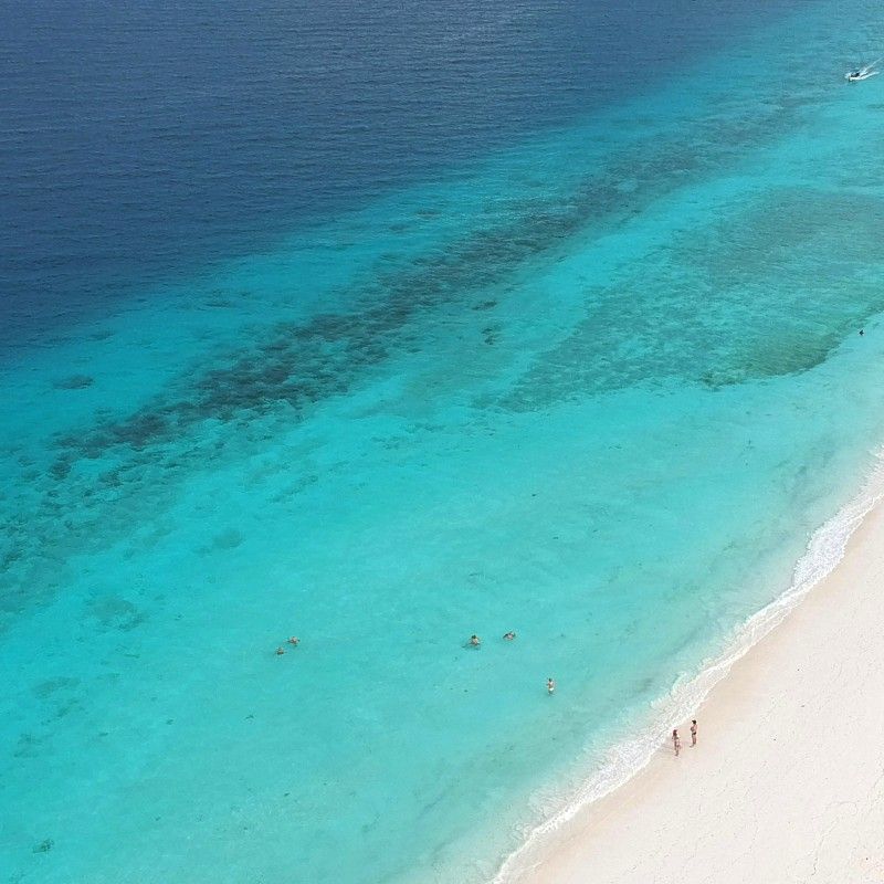 Behold this breathtaking aerial photo of a beach in Zanzibar, Tanzania. The pure, dazzling white sand creates a striking contrast against the impossibly clear, turquoise water that surrounds it, showcasing this pristine island paradise from above. Nakupenda is the ultimate escape for swimming, sunbathing, and snorkeling. Inspiration Africa is ready to design your perfect, tailor-made trip to Zanzibar and many other unforgettable African destinations. Book your dream beach holiday and explore this jewel of the Indian Ocean with us!