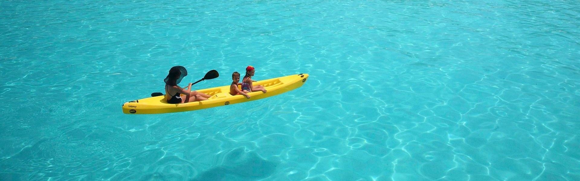 A family moment unfolds beautifully in this heart-warming travel photograph of a mother and her two young children sea kayaking off Mnemba Island, Zanzibar, Tanzania. The clear, turquoise waters gently ripple beneath their kayak as they glide across the ocean, surrounded by vibrant marine hues and the island’s pristine shoreline in the distance. Sunlight dances on the water’s surface, creating a joyful, carefree atmosphere that captures both adventure and togetherness. The scene conveys connection, exploration, and the magic of sharing nature with loved ones, highlighting Mnemba Island as an ideal destination for families seeking meaningful, memorable experiences in one of East Africa’s most idyllic island settings. Inspiration Africa specializes in bespoke, tailor-made journeys to Zanzibar and across Africa, crafting unforgettable travel experiences for couples and families alike.
