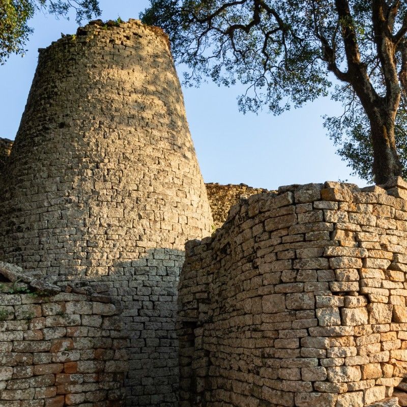 Gaze upon the ancient stone ruins of Great Zimbabwe, a UNESCO World Heritage Site and the heart of a powerful medieval kingdom. This striking photograph captures the impressive dry-stone architecture, including towering walls and circular enclosures, reflecting centuries of ingenuity, culture, and history. Once a thriving center of trade and civilization, Great Zimbabwe stands as a testament to Africa’s rich heritage and architectural achievement. Visiting these iconic ruins offers a profound connection to the continent’s past. Inspiration Africa specializes in designing bespoke, tailor-made journeys that combine historical exploration with extraordinary experiences across Africa’s most remarkable destinations.
