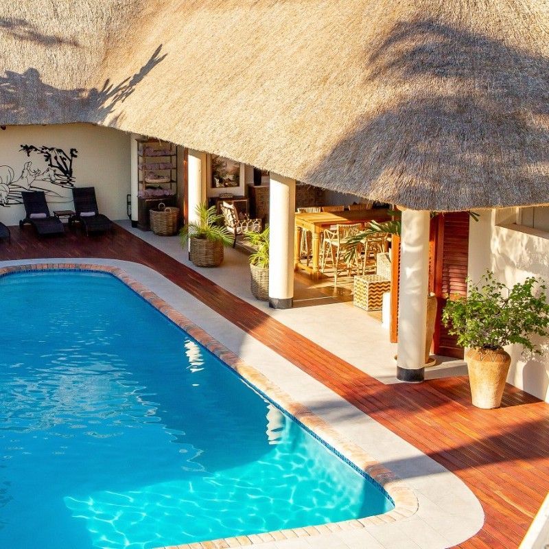 The swimming pool and outdoor area at Ilala Lodge in Victoria Falls, Zimbabwe, are captured in this inviting travel photograph, showcasing a tranquil space for relaxation and leisure. The pool’s calm waters reflect the surrounding greenery, sun loungers, and shaded areas, creating a serene and comfortable environment for guests. Lush gardens and mature trees frame the scene, enhancing the sense of privacy and connection to nature while providing a peaceful retreat within the lodge grounds. The image conveys the essence of a relaxing stay near one of Zimbabwe’s most iconic destinations, combining comfort, elegance, and a welcoming outdoor atmosphere. Inspiration Africa specializes in bespoke, tailor-made journeys to Zimbabwe and across Africa, crafting unforgettable travel experiences in extraordinary destinations.
