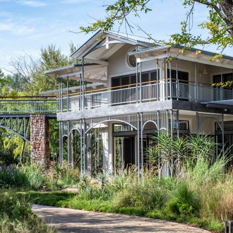 The entrance of the Palm River Hotel in Zimbabwe is captured in this welcoming travel photograph, showcasing a stylish arrival set along the banks of the Zambezi River near Victoria Falls. A graceful driveway leads to the hotel’s elegant façade, framed by lush gardens, palm trees, and contemporary architectural details that create a strong sense of place. Natural materials and refined design elements reflect the hotel’s blend of modern luxury and riverside tranquility. The scene conveys a warm and inviting first impression, offering guests a glimpse of the comfort, sophistication, and relaxed atmosphere that define a stay at Palm River Hotel. Inspiration Africa specializes in bespoke, tailor-made journeys to Zimbabwe and across Africa, crafting unforgettable travel and safari experiences in extraordinary destinations.
