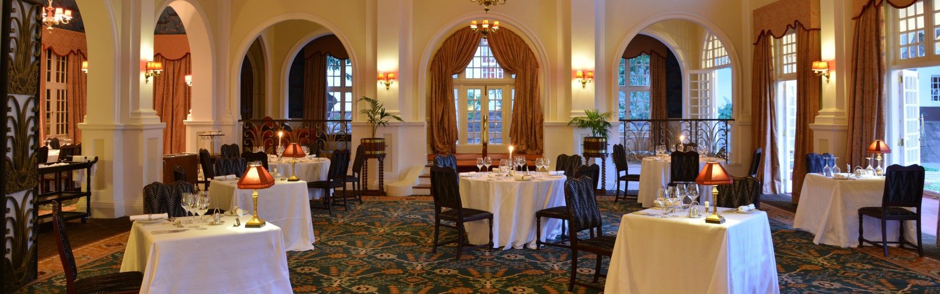 The beautifully decorated interior of the Livingstone Room at The Victoria Falls Hotel in Zimbabwe is showcased in this elegant travel photograph, highlighting the timeless grandeur of one of Africa’s most iconic heritage hotels. Refined furnishings, classic décor, and rich fabrics reflect a colonial-era elegance, while carefully curated details and soft lighting create an atmosphere of sophistication and luxury. Large windows and high ceilings enhance the sense of space, offering a graceful and refined dining environment steeped in history. The scene captures the prestige and charm that define The Victoria Falls Hotel, presenting an unforgettable setting where tradition, comfort, and exceptional hospitality come together. Inspiration Africa specializes in bespoke, tailor-made journeys to Zimbabwe and across Africa, crafting unforgettable travel experiences in extraordinary destinations.
