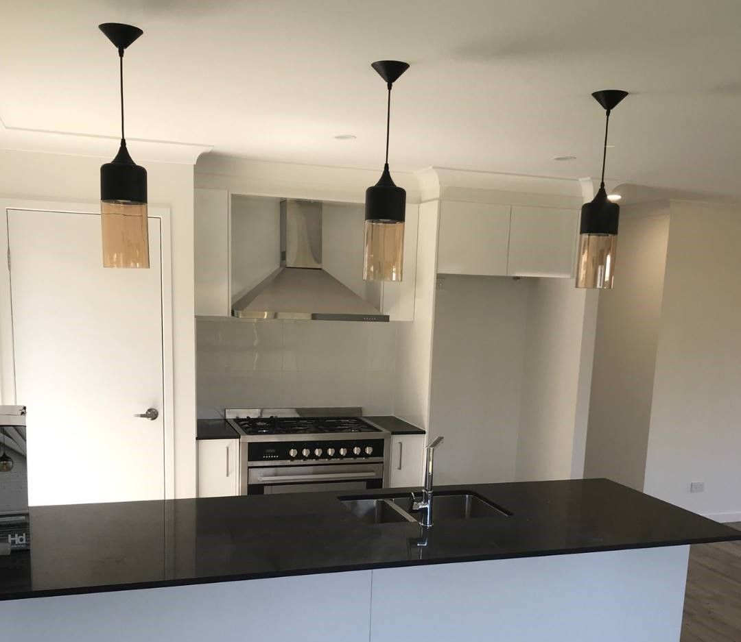 A Kitchen With A Stove Top Oven And A Sink — Joyner Electrical Pty Ltd In Carrara, QLD