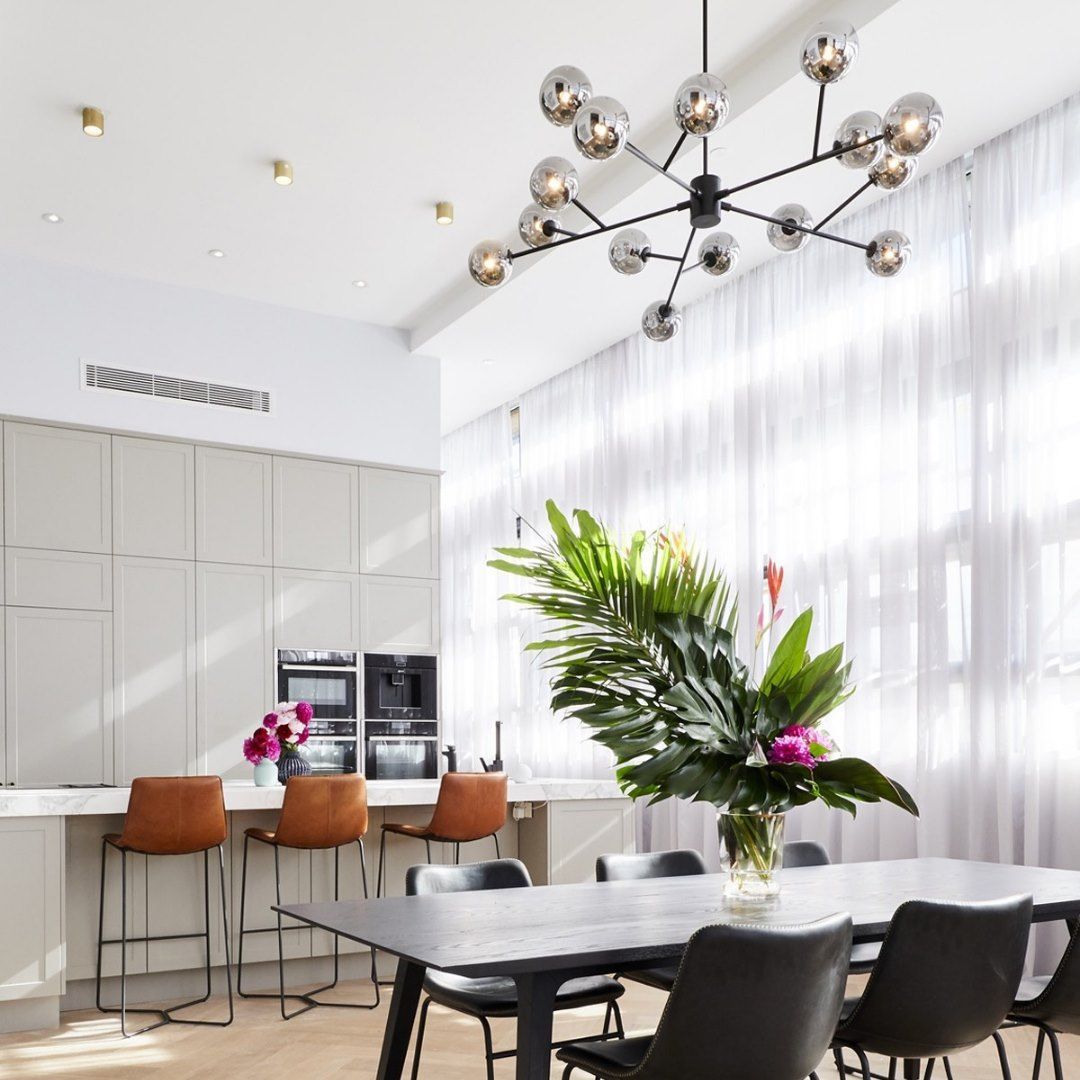 A Dining Room With A Table And Chairs And A Chandelier Hanging — Joyner Electrical Pty Ltd In Molendinar, QLD 