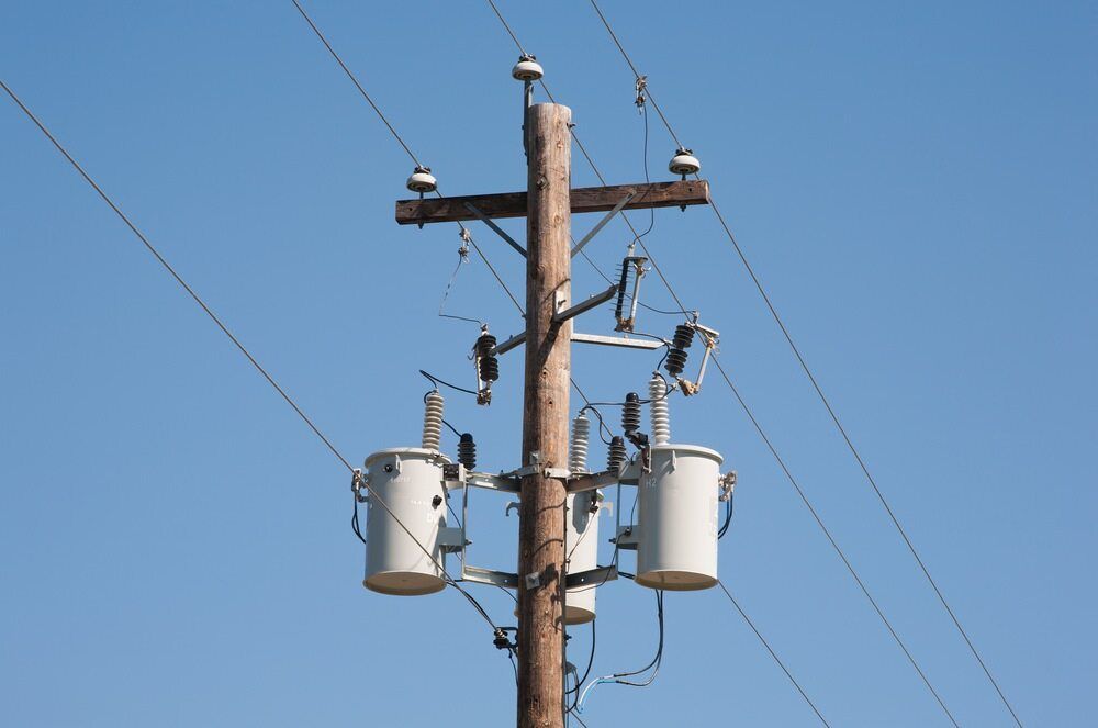 A Telephone Pole With Two Transformers Attached to It — Joyner Electrical Pty Ltd In Carrara, QLD