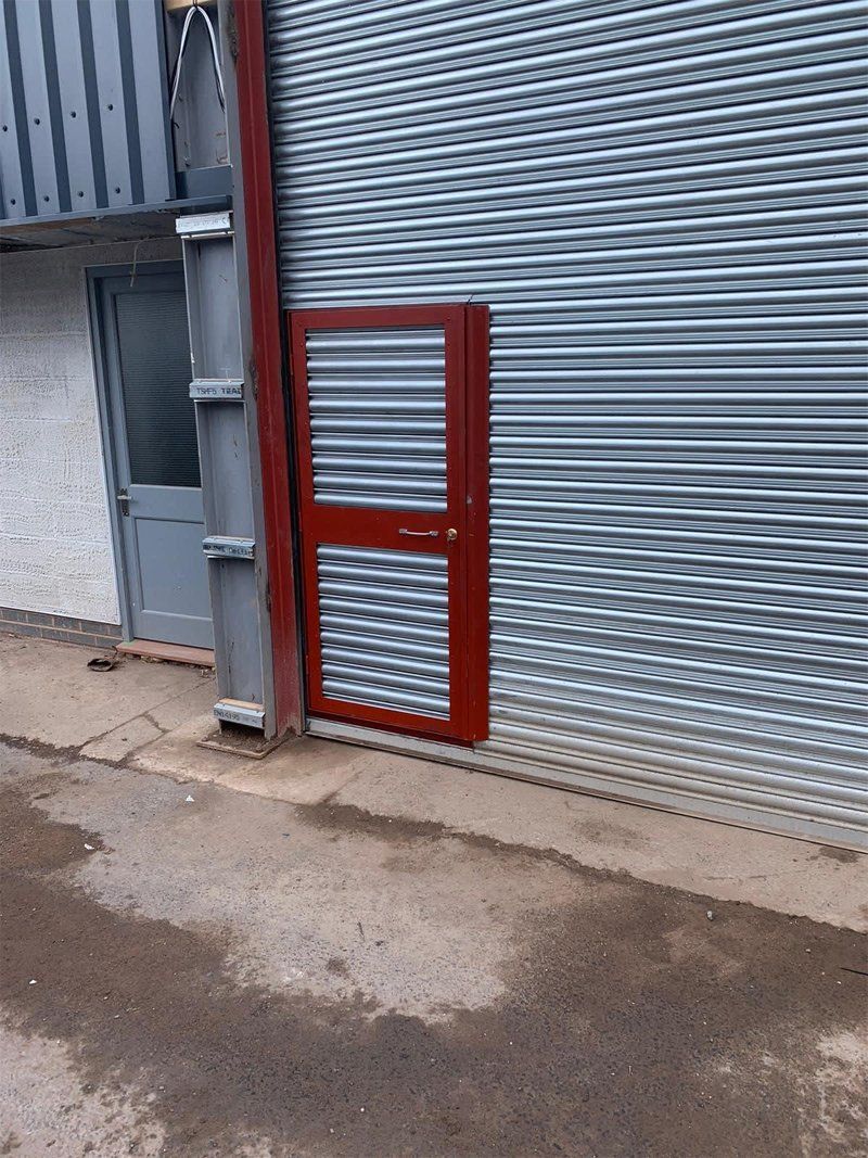 Grey shutter door with inset standard door