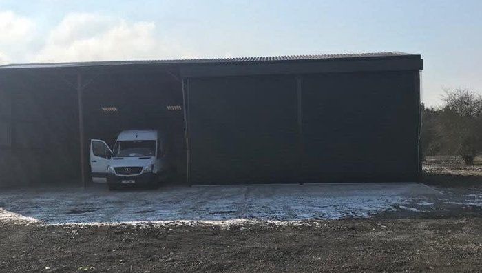 Large warehouse with van coming out of shutter door
