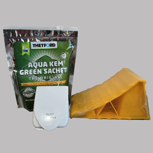 A package of green Thetford Aqua Kem, white cassette toilet, and a yellow wheel chock. — Rainbow Beach 4x4 Accessories in Rainbow Beach, QLD