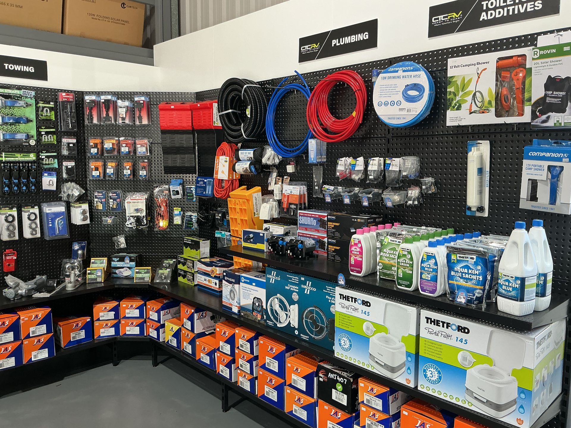 A store display showcasing various boating and marine supplies, with hoses, boxes, and accessories on shelves. — Rainbow Beach 4x4 Accessories in Rainbow Beach, QLD