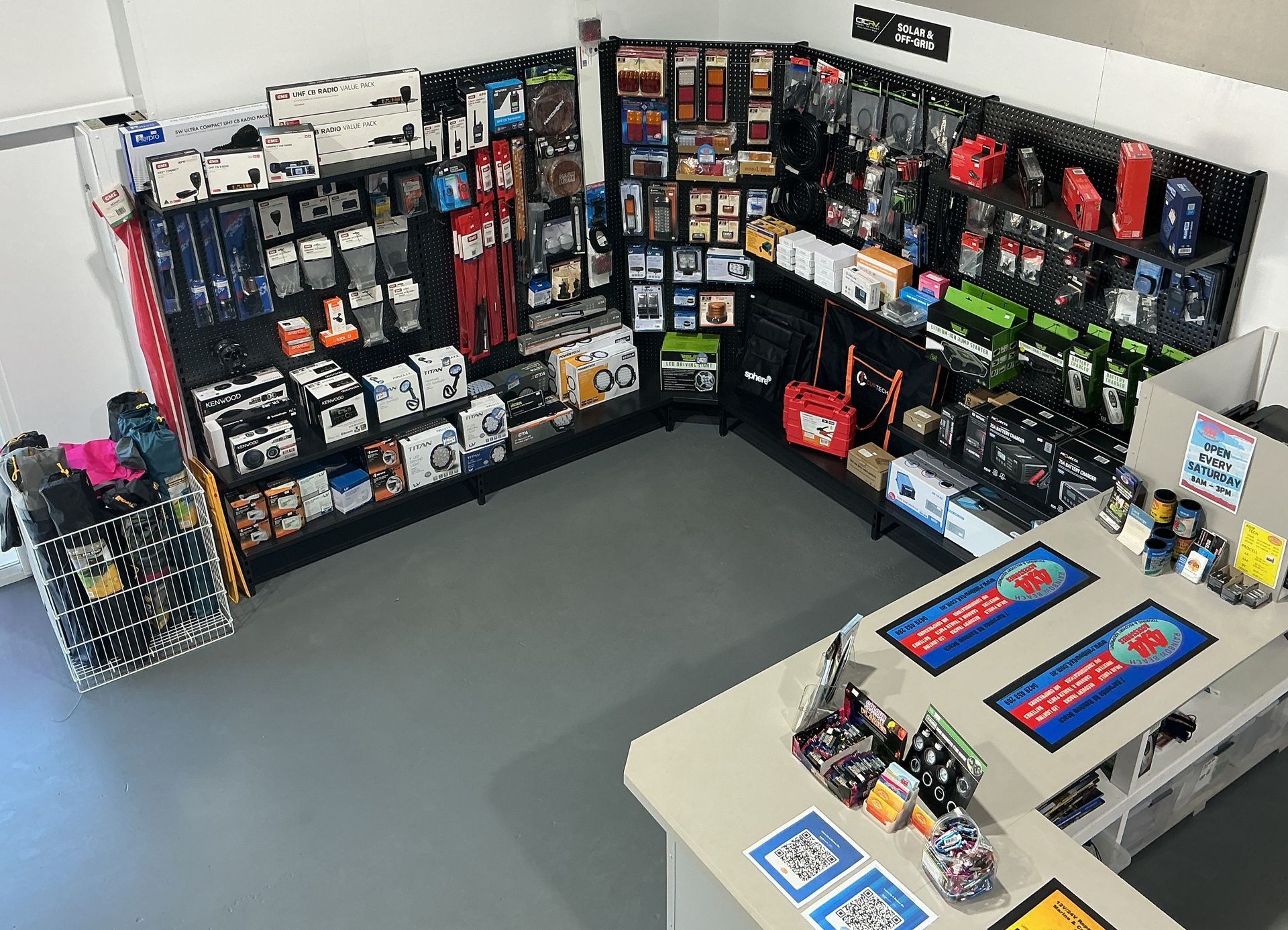 Corner retail display with phone accessories and a checkout counter. — Rainbow Beach 4x4 Accessories in Rainbow Beach, QLD