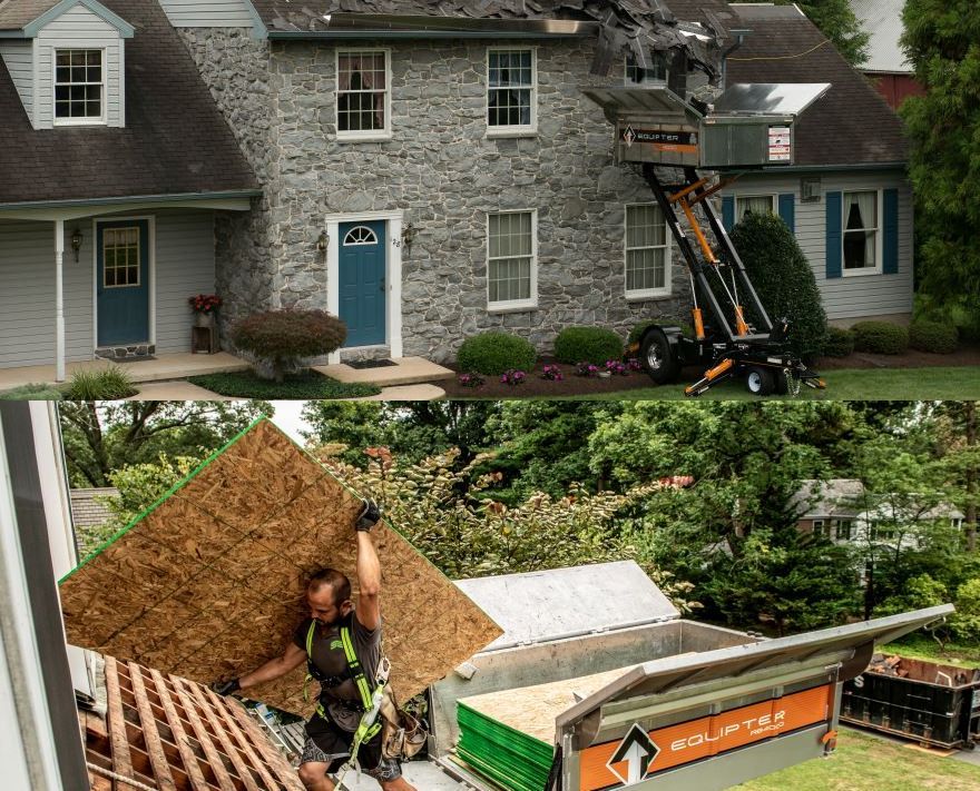 A man is carrying a piece of plywood in front of a house