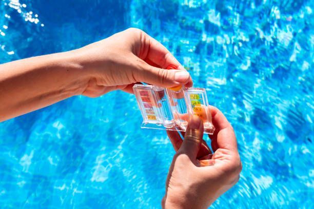 A Person is Holding a Test Tube in Front of a Swimming Pool — Dunckers in Nambour, QLD