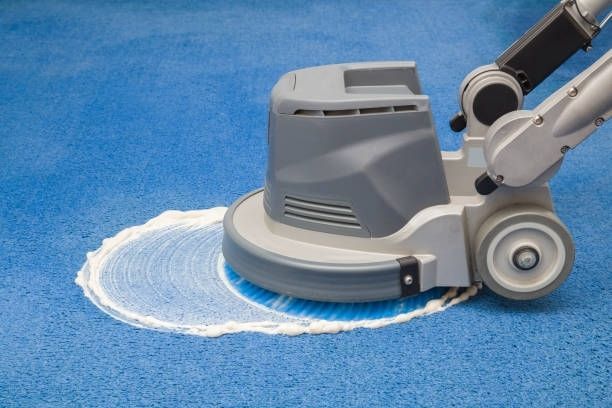 A Person is Using a Machine to Clean a Blue Carpet — Dunckers in Nambour, QLD