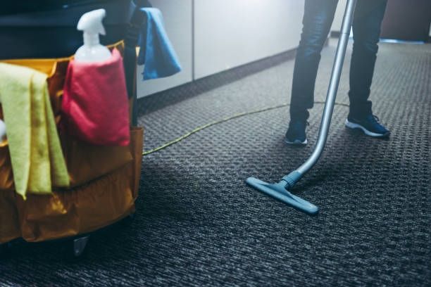 A Person is Cleaning a Carpet With a Vacuum Cleaner — Dunckers in Nambour, QLD