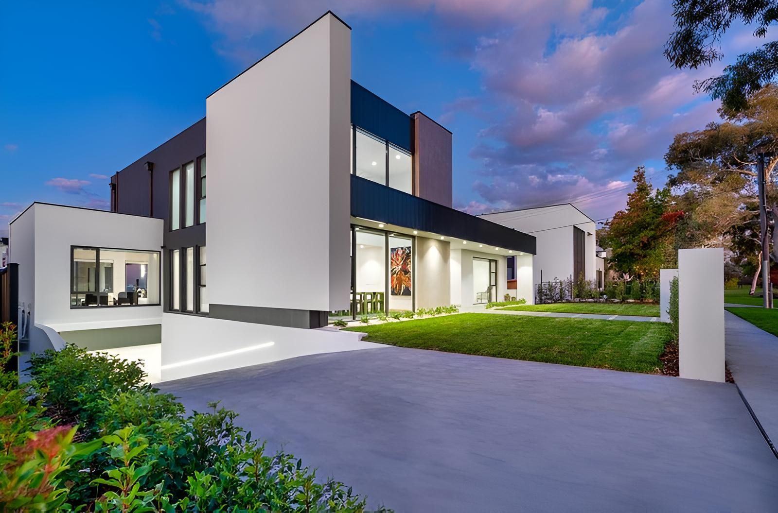 A Large Modern House With a Lot of Windows and a Driveway — Elite Window Furnishings In Fyshwick, ACT