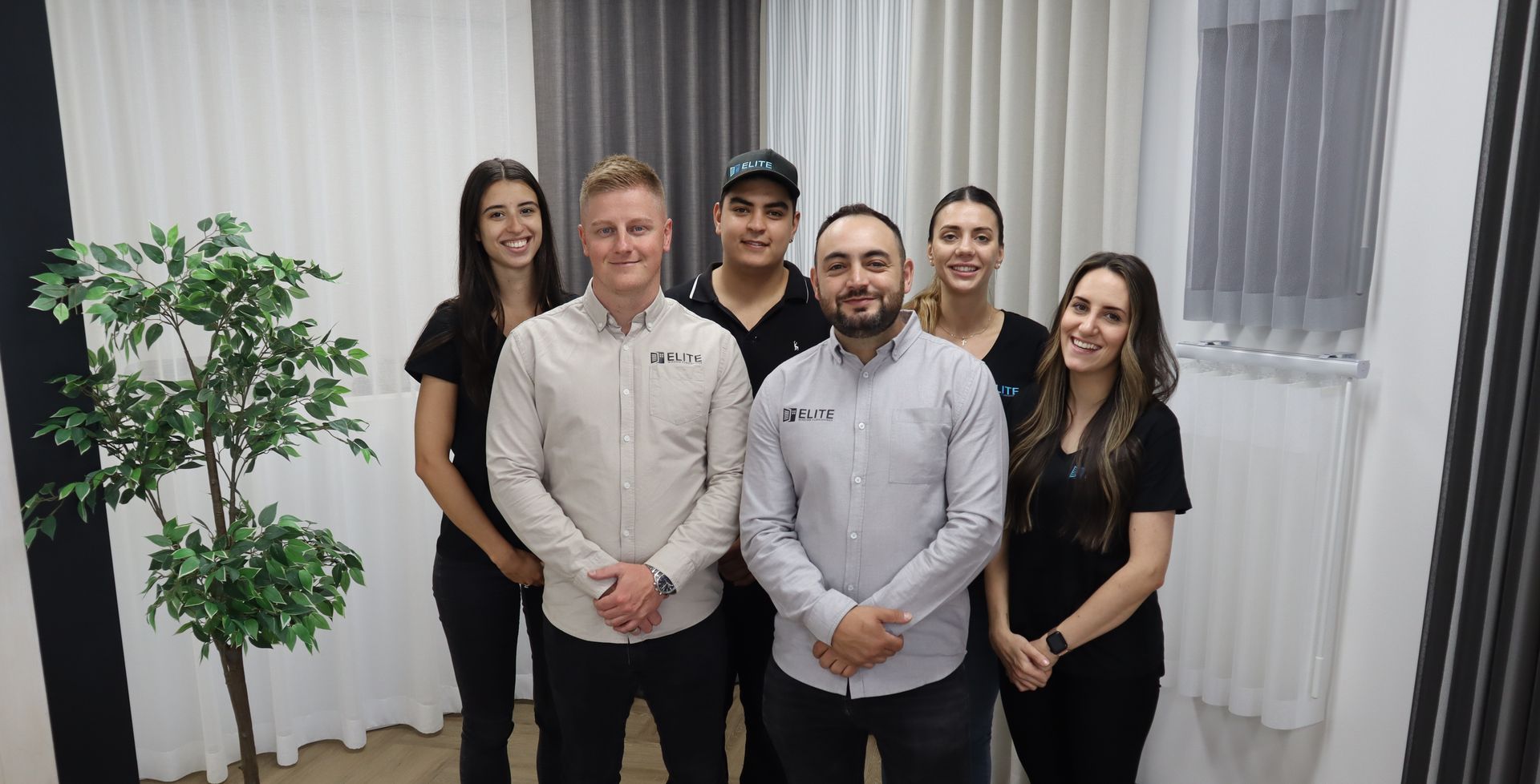 Man is Helping Woman Choose Product From A Binder - Elite Window Furnishings In Fyshwick, ACT