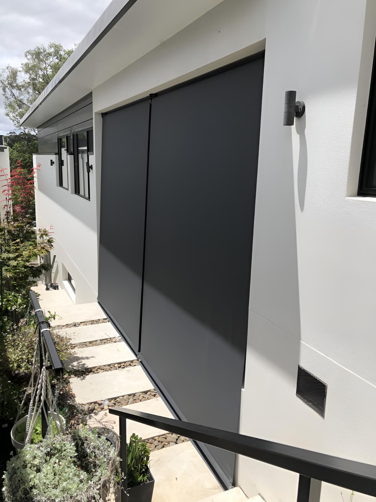 A white house with a black door and stairs — Elite Window Furnishings In Fyshwick, ACT