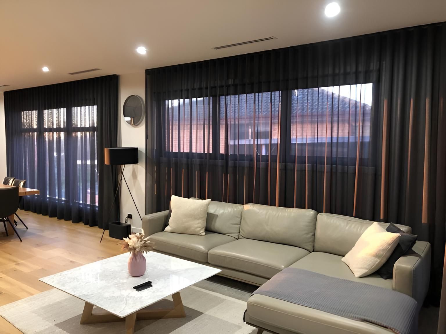 A living room with a couch , coffee table , and curtains — Elite Window Furnishings In Fyshwick, ACT