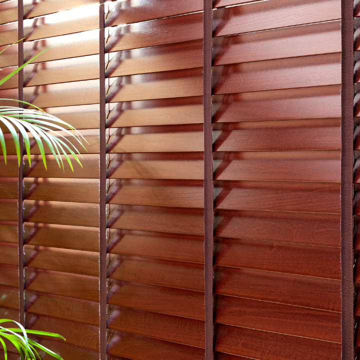 A close up of a wooden blind with a palm tree in the background — Elite Window Furnishings In Fyshwick, ACT