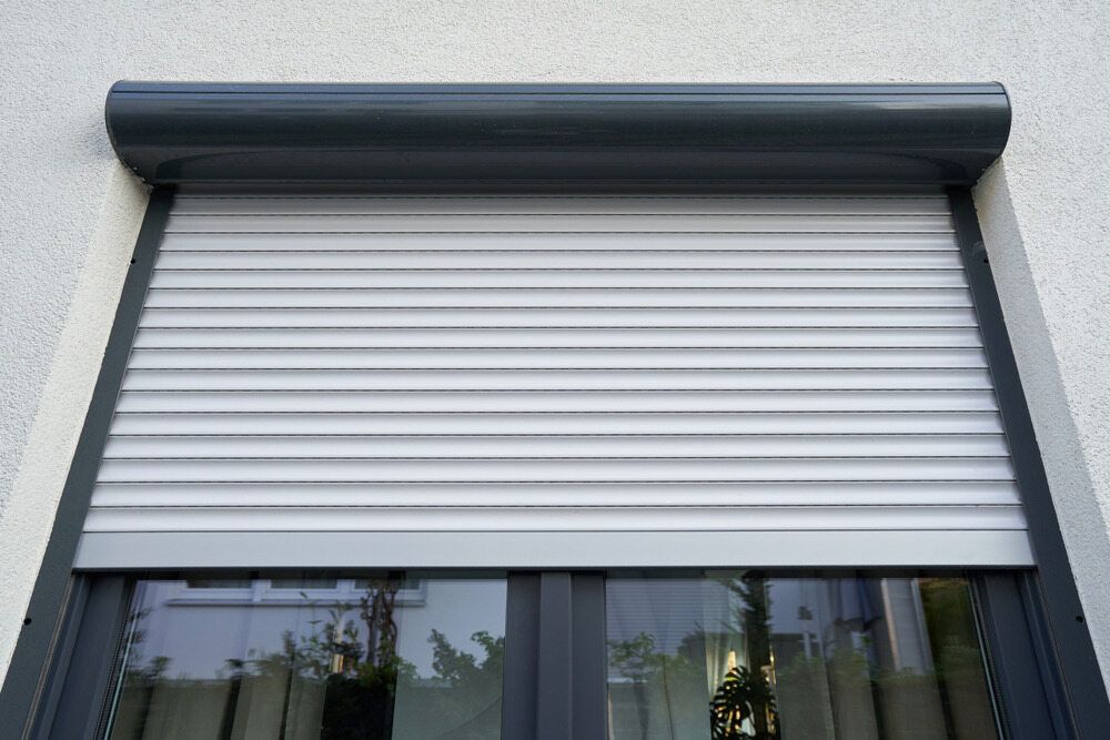 A Close Up of a Window With a Roller Shutter on It — Elite Window Furnishings In Fyshwick, ACT