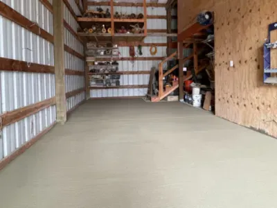 A large empty garage with a concrete floor and wooden walls in Salem, OR.