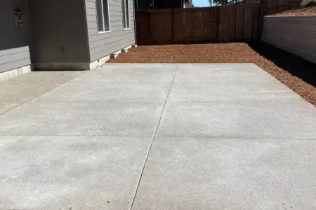 A concrete driveway in front of a house with exposed aggregate finish in Salem, OR.