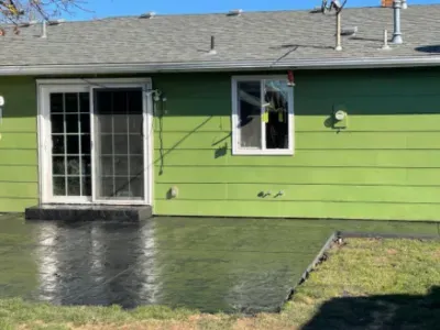 Stamped concrete patio in front of a green house in Salem, OR