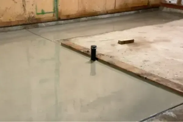 A concrete driveway is being built in a backyard.
