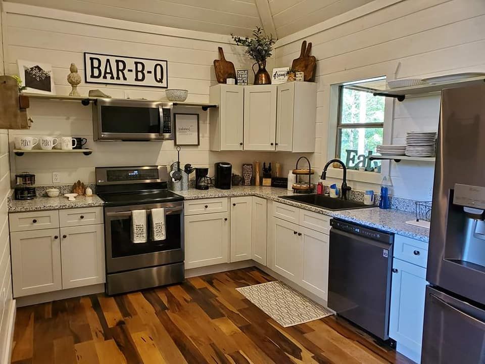 A kitchen with stainless steel appliances and white cabinets