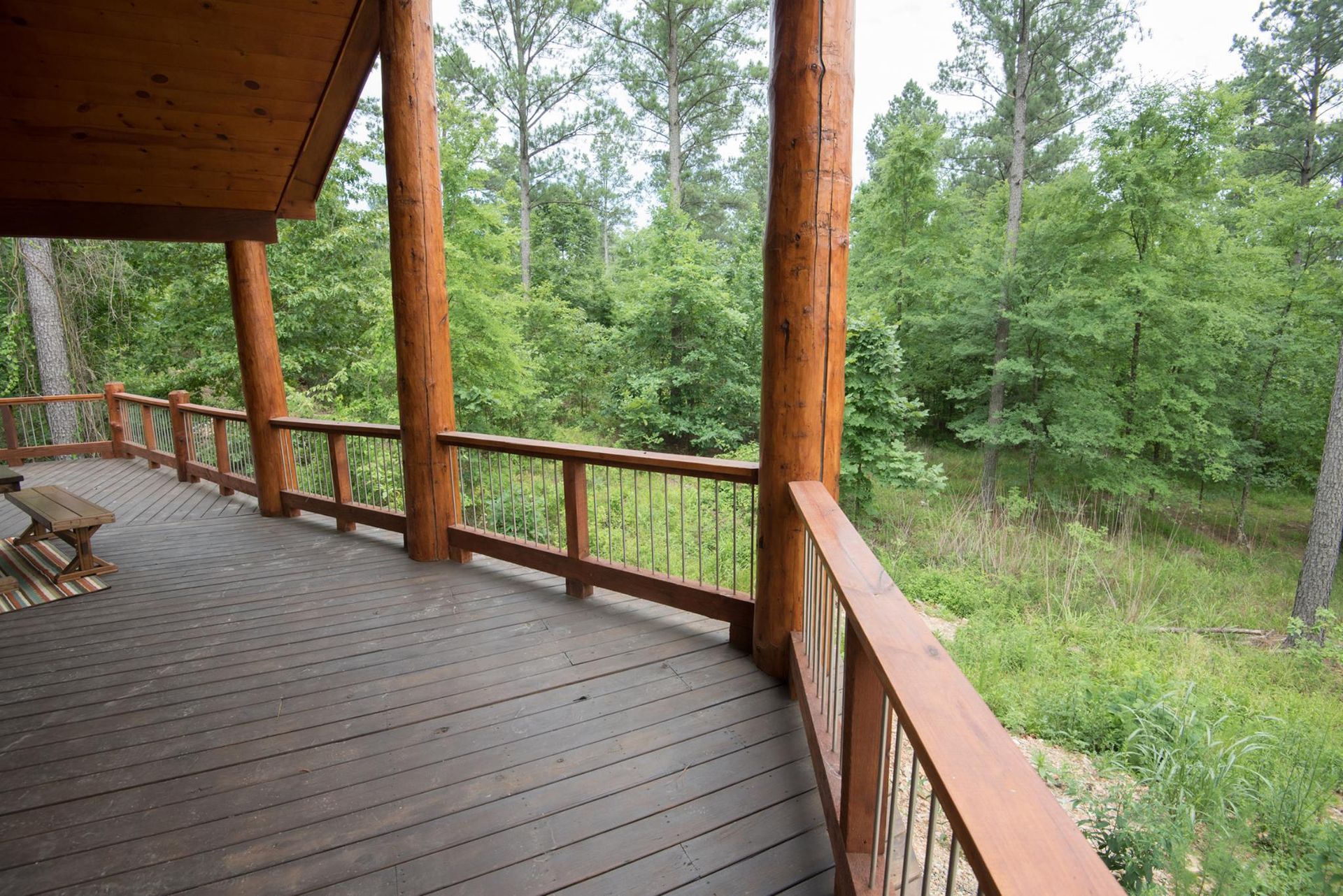 A wooden deck with a view of a forest