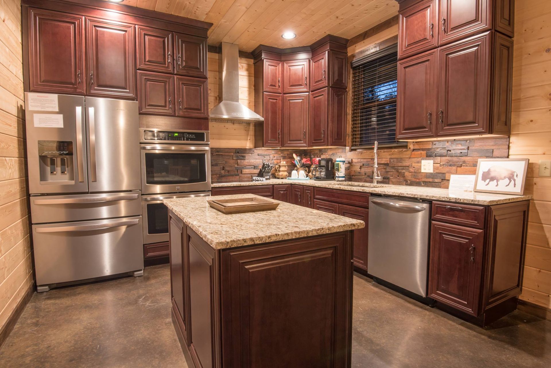 A kitchen with stainless steel appliances and wooden cabinets.