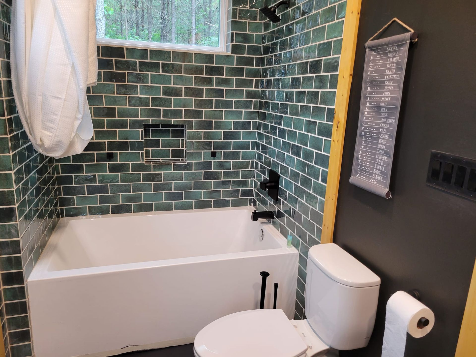 A bathroom with a toilet , bathtub , and shower.