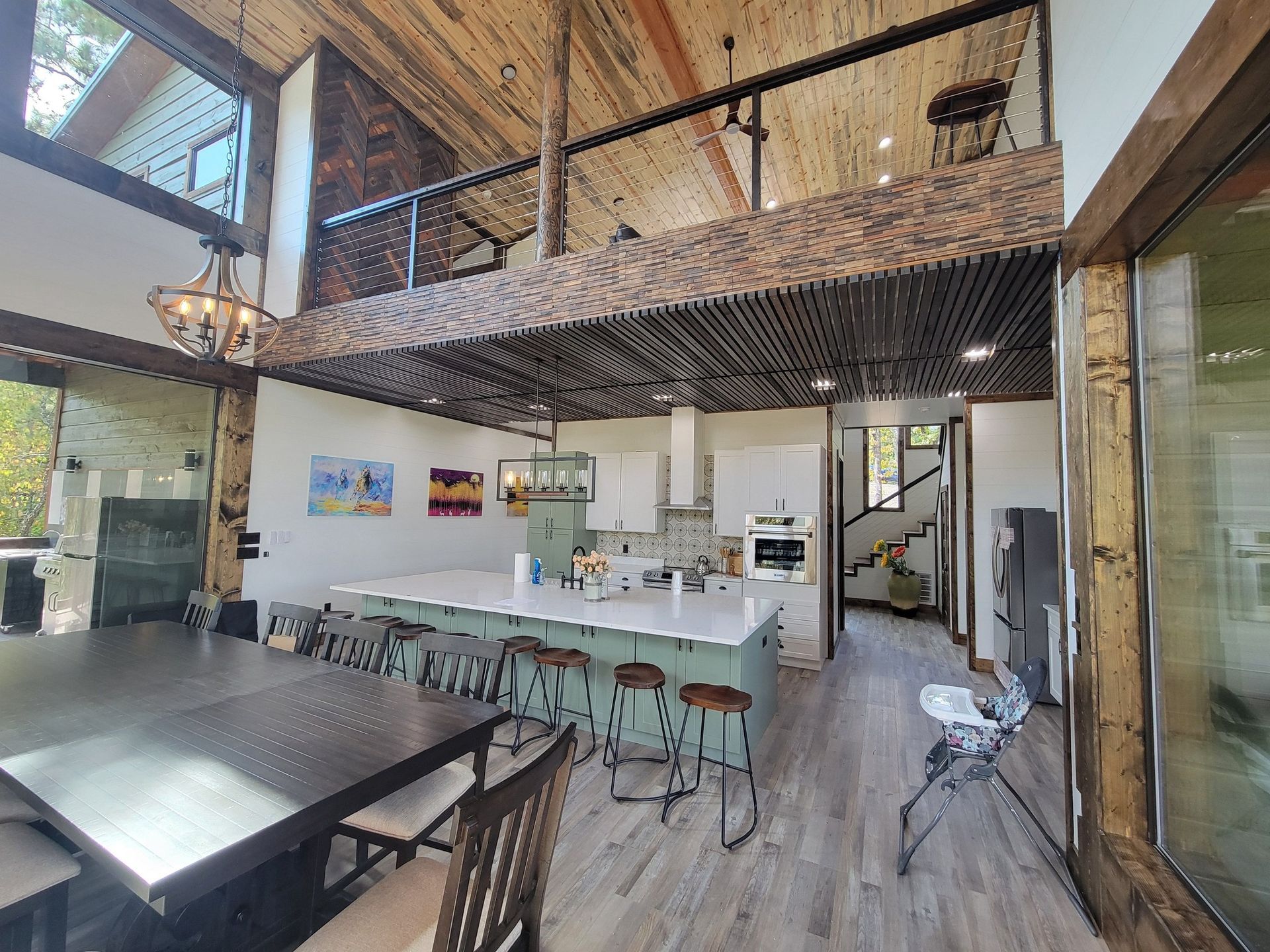 There is a table and chairs in the middle of the room.