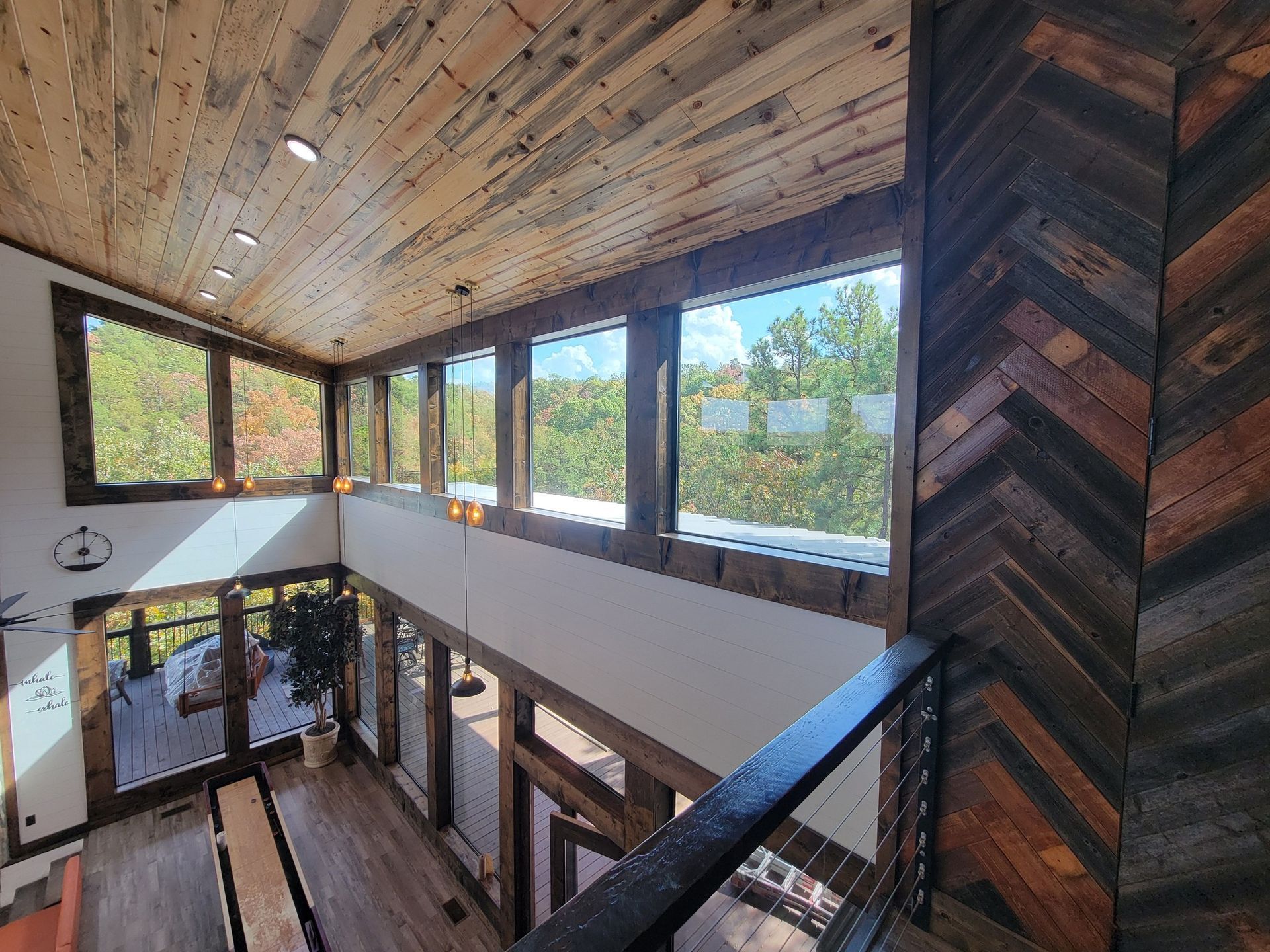 A large room with a lot of windows and a wooden ceiling.