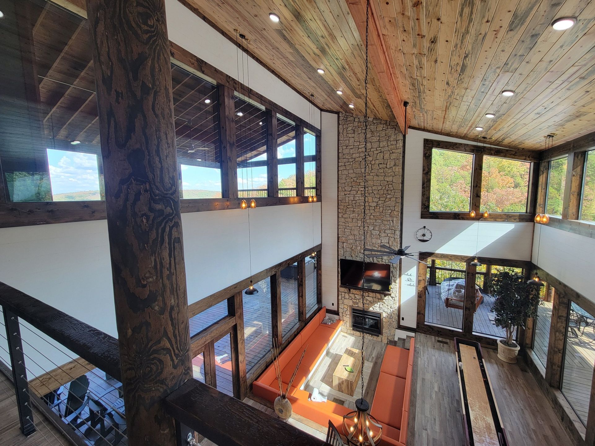 A large room with a lot of windows and a wooden ceiling.