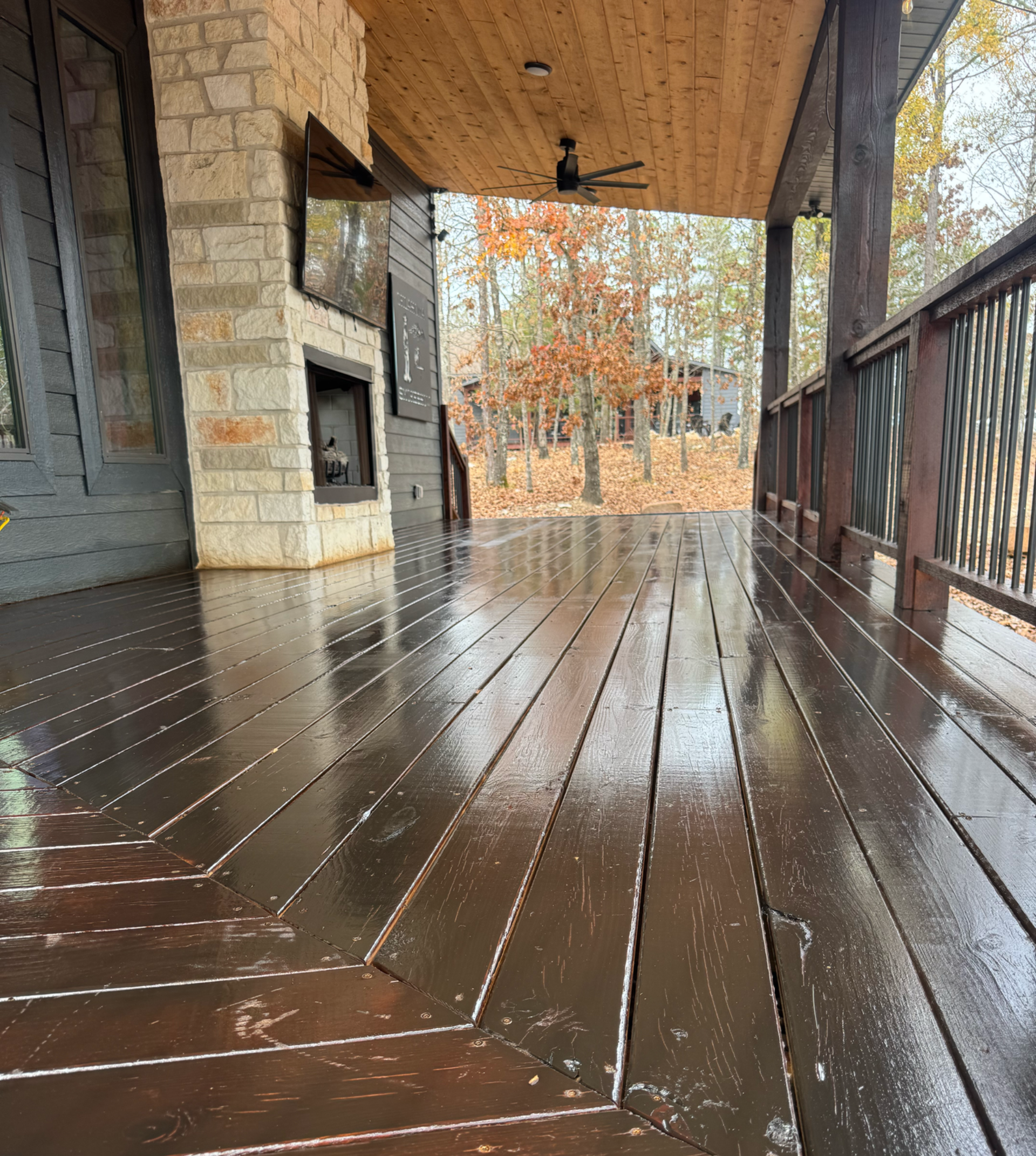 A wooden deck with a view of a forest