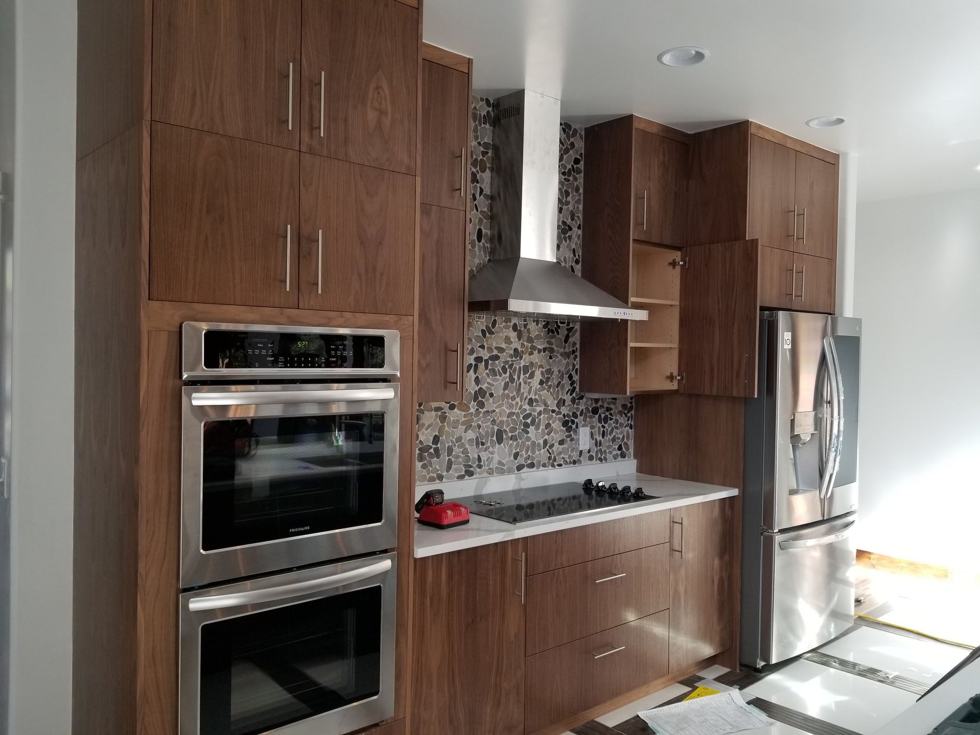 A kitchen with stainless steel appliances and wooden cabinets