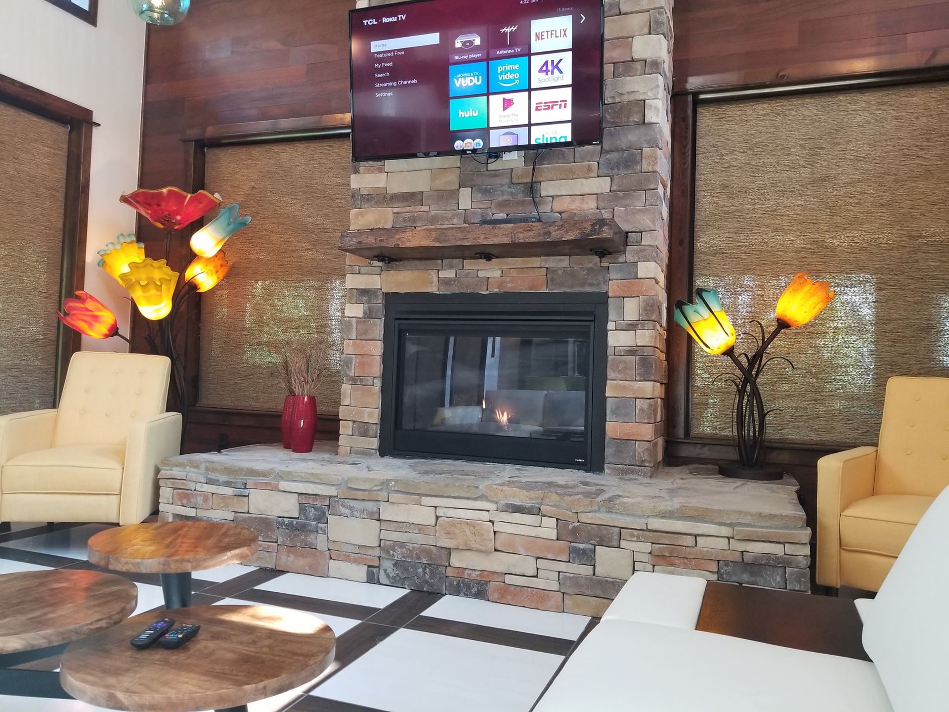 A living room with a fireplace and a flat screen tv