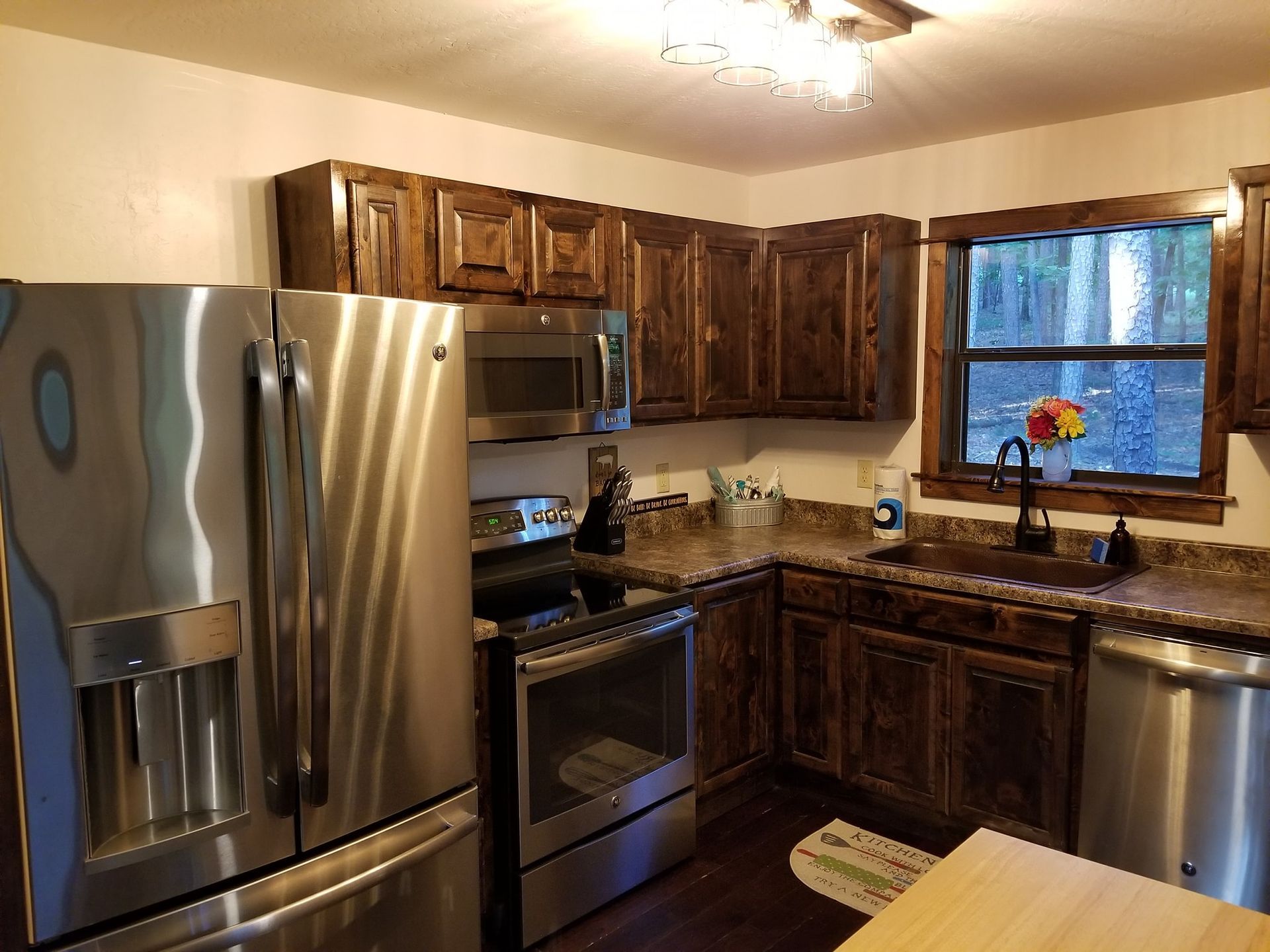 A kitchen with stainless steel appliances and wooden cabinets