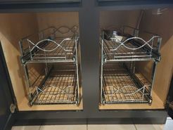 A kitchen sink with two drawers underneath it.