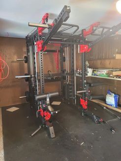 A gym with a lot of exercise equipment in it.