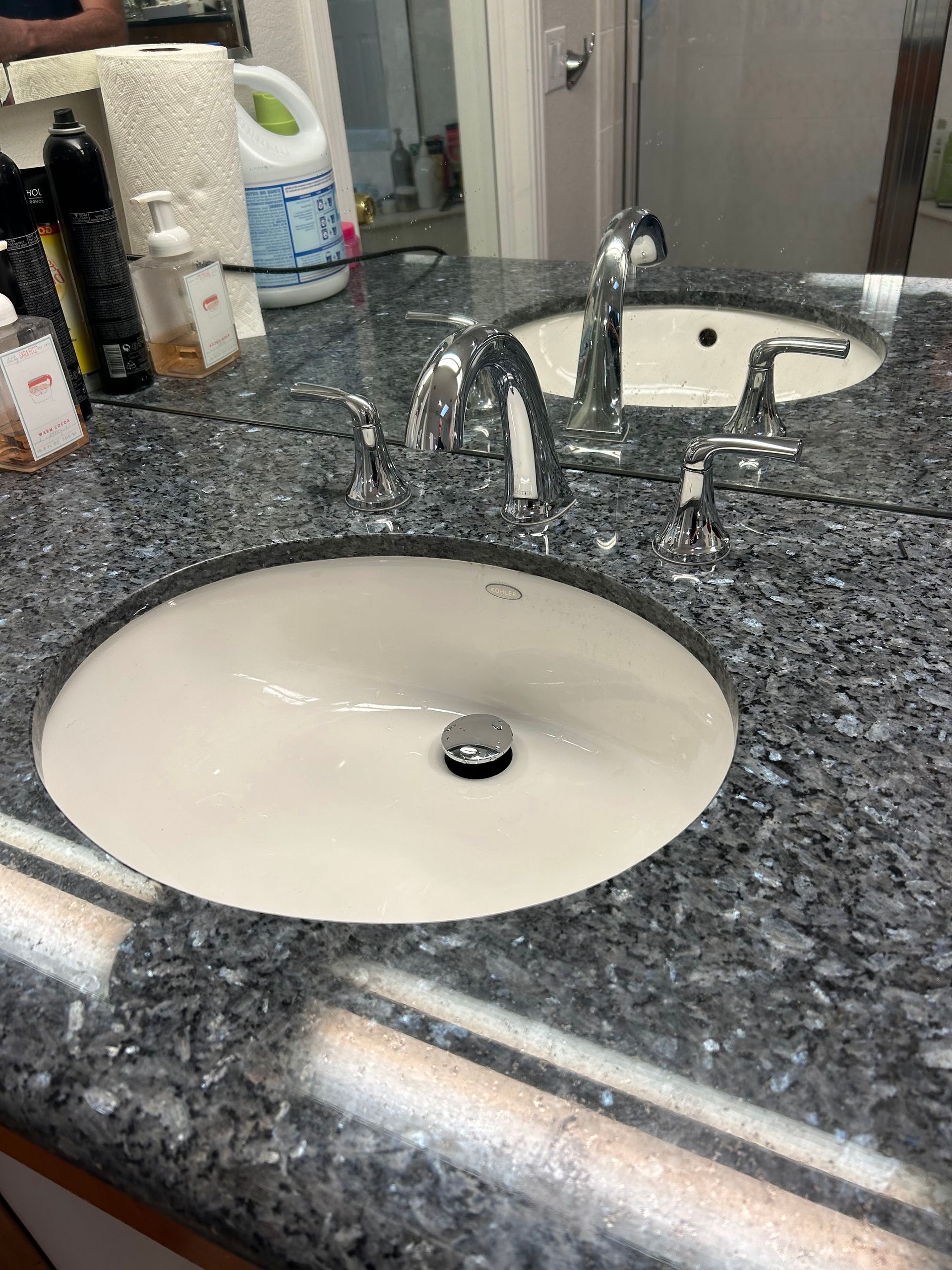 Granite bathroom countertop with white sink and chrome faucet рядом