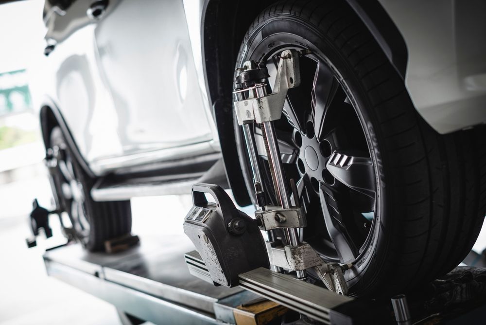 A Car is Being Adjusted on a Machine in a Garage — Port Macquarie Automotive Specialists in Port Macquarie, NSW