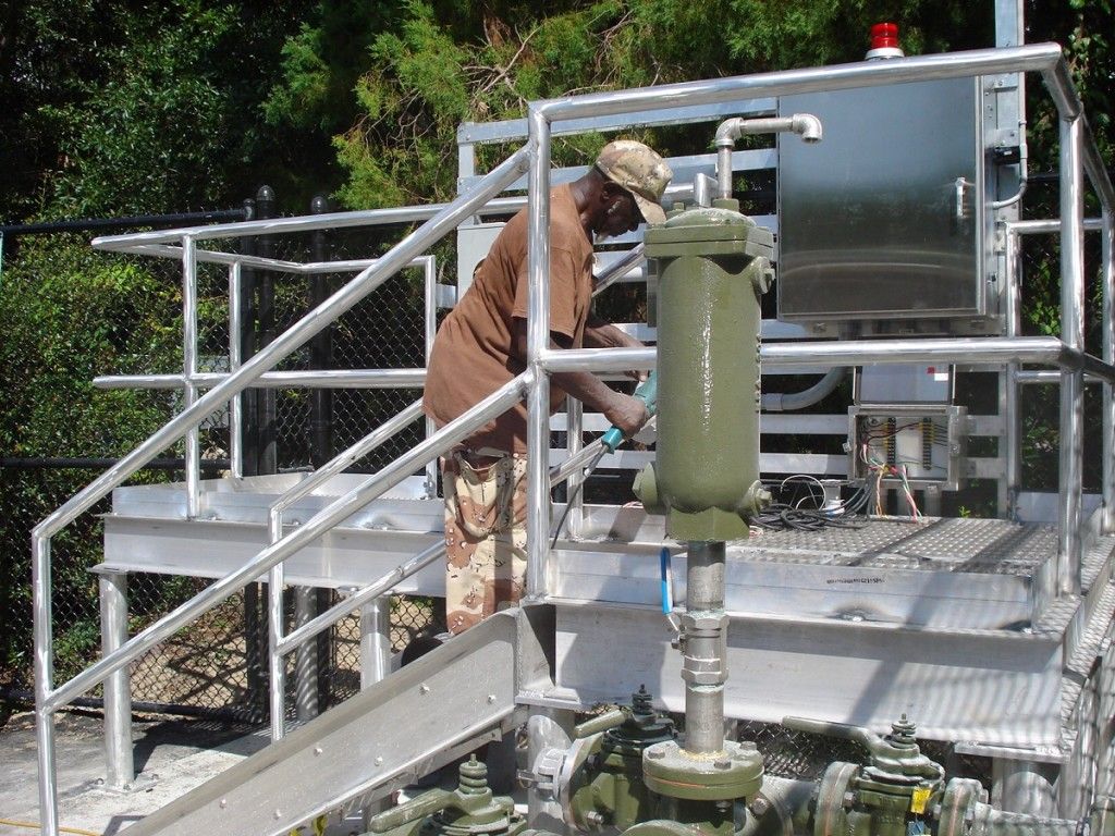 A man standing on a platform working on a machine