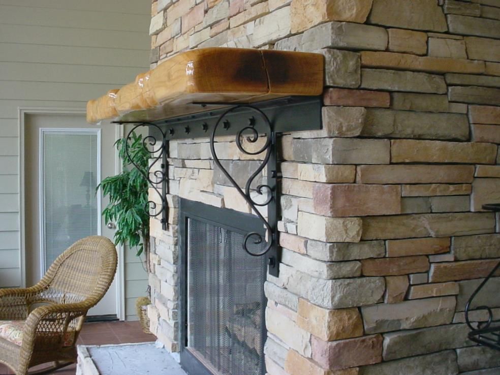 A stone fireplace with a wicker chair in front of it