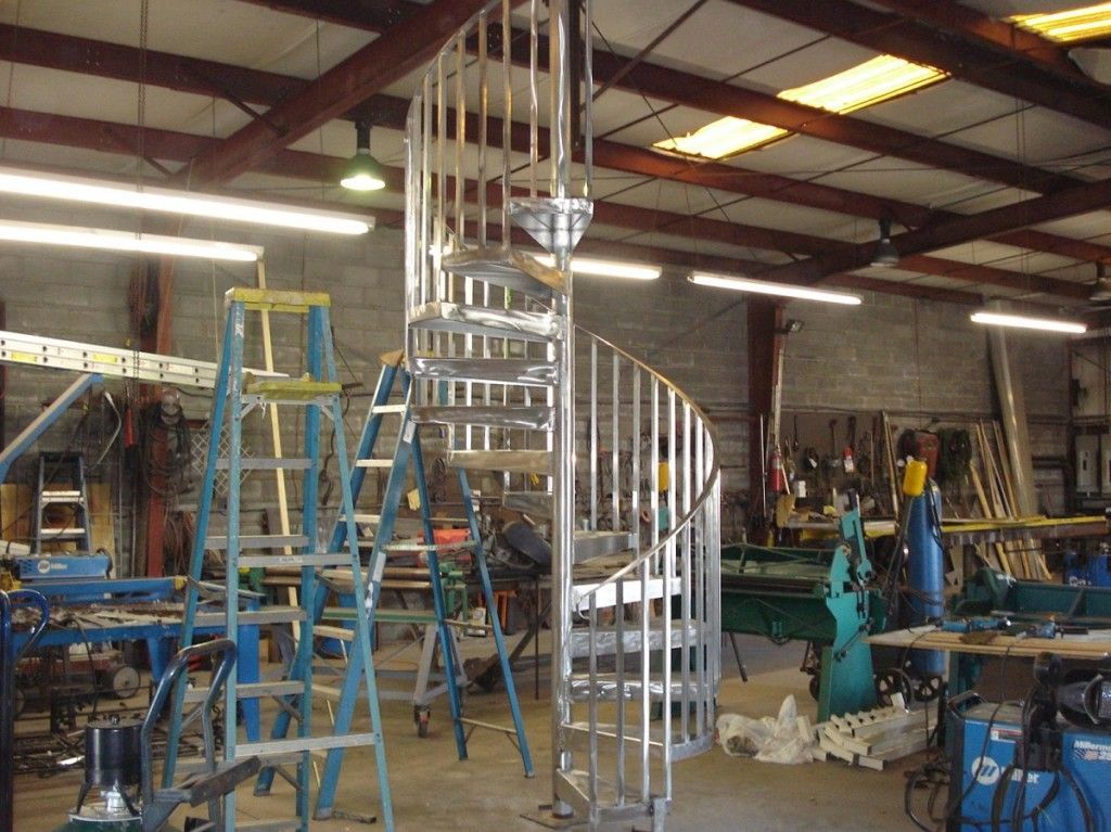 A spiral staircase is being built in a factory