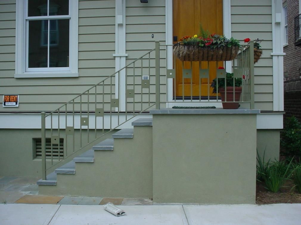 A house with a yellow door and a sign that says no