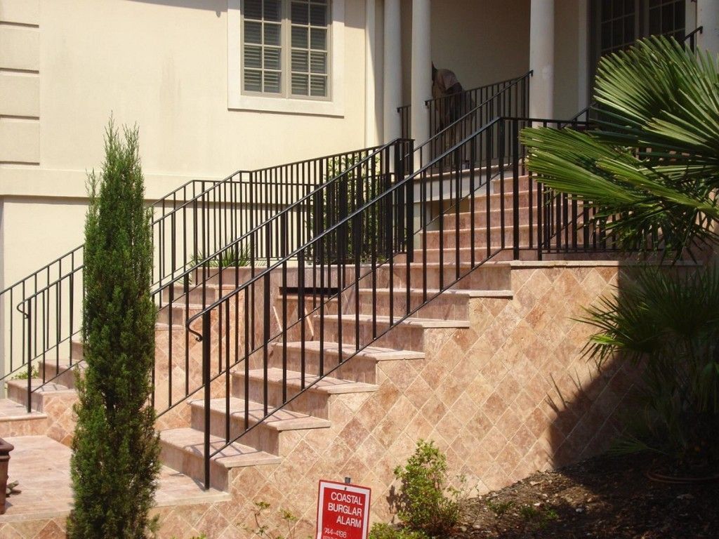 A staircase with a wrought iron railing and a sign that says do not enter