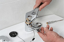 Plumber repairing the faucet of a sink - Plumbing Service & Repair in Perkasie, PA